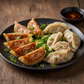 Chicken Dumplings showing both golden pan-fried potstickers and delicate steamed dumplings on a dark ceramic plate with soy chili dipping sauce