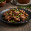 Lamb Pepper Fry on a dark ceramic plate with tender lamb pieces stir-fried with black pepper, curry leaves, onions and green chilies in South Indian style